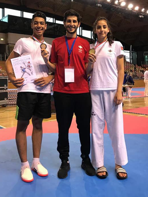 Taekwondo champions Natalie Hamidi and Fahed Ammar with Coach Laith Izzat