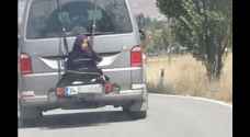 Video: Turkish father straps teen daughter to back of his minivan