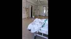 Al-Bashir Hospital paints ward's walls while patients watch from their beds