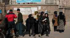 Armed guards stop Afghan women entering universities after Taliban ban