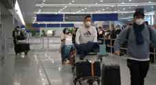 China ends quarantine for overseas travelers