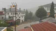 Torrential rains kill one in Greece after wildfires