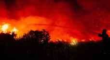 Firefighters battle peatland blazes as haze shrouds Indonesian city