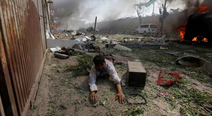 A wounded man at the site of a huge explosion in Kabul, the capital of Afghanistan, on Wednesday. The bombing killed at least 80 people and injured hu