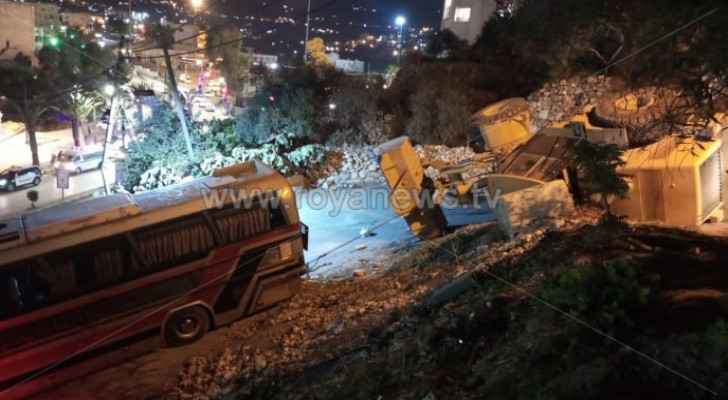 Bulldozer overturns trying to pull out stuck tourist bus