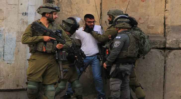 The Israeli Occupation Forces (IOF) arrest a Palestinian in the West Bank. (File photo: AA) 