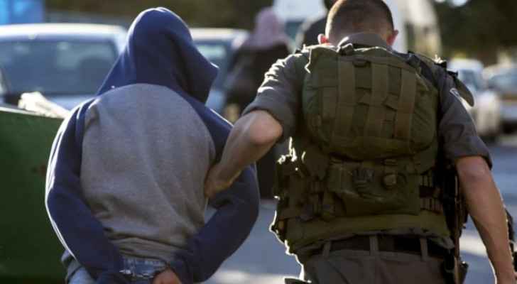 Israeli Occupation Forces detaining a Palestinian