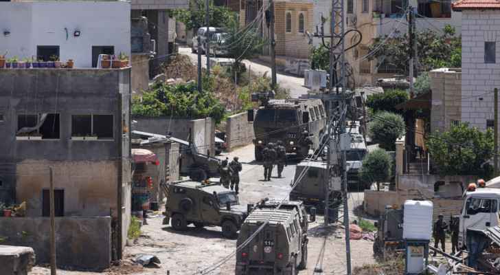 “Israeli” army vehicles block a road during a raid in the town of Deir al-Ghusun near Tulkarem (May 4, 2024) (Photo: AFP)