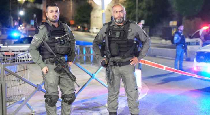 Two "Israeli" police officers at the scene of the alleged stabbing, according to occupation.