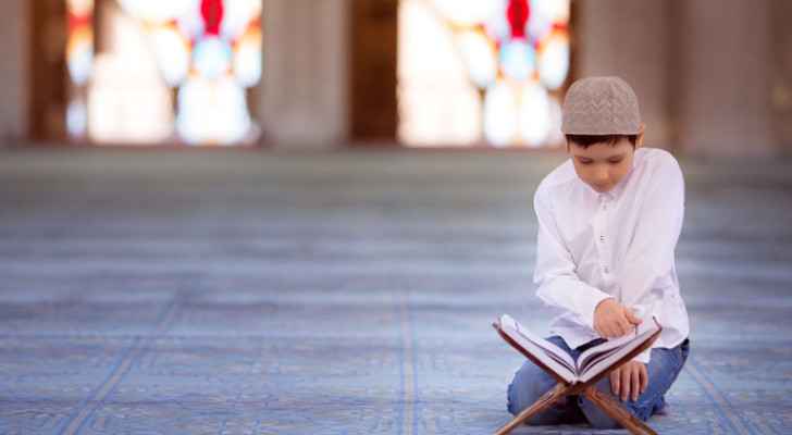Kid reading Quran.