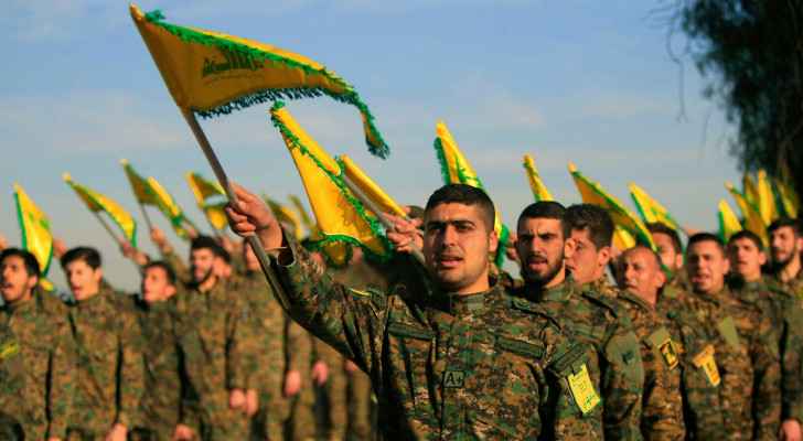Hezbollah fighters hold the group’s flag in South Lebanon. (February 13, 2016) (Photo: AP) 
