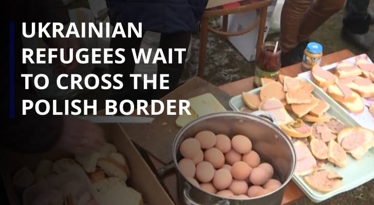 Ukrainian refugees wait to cross the Polish border